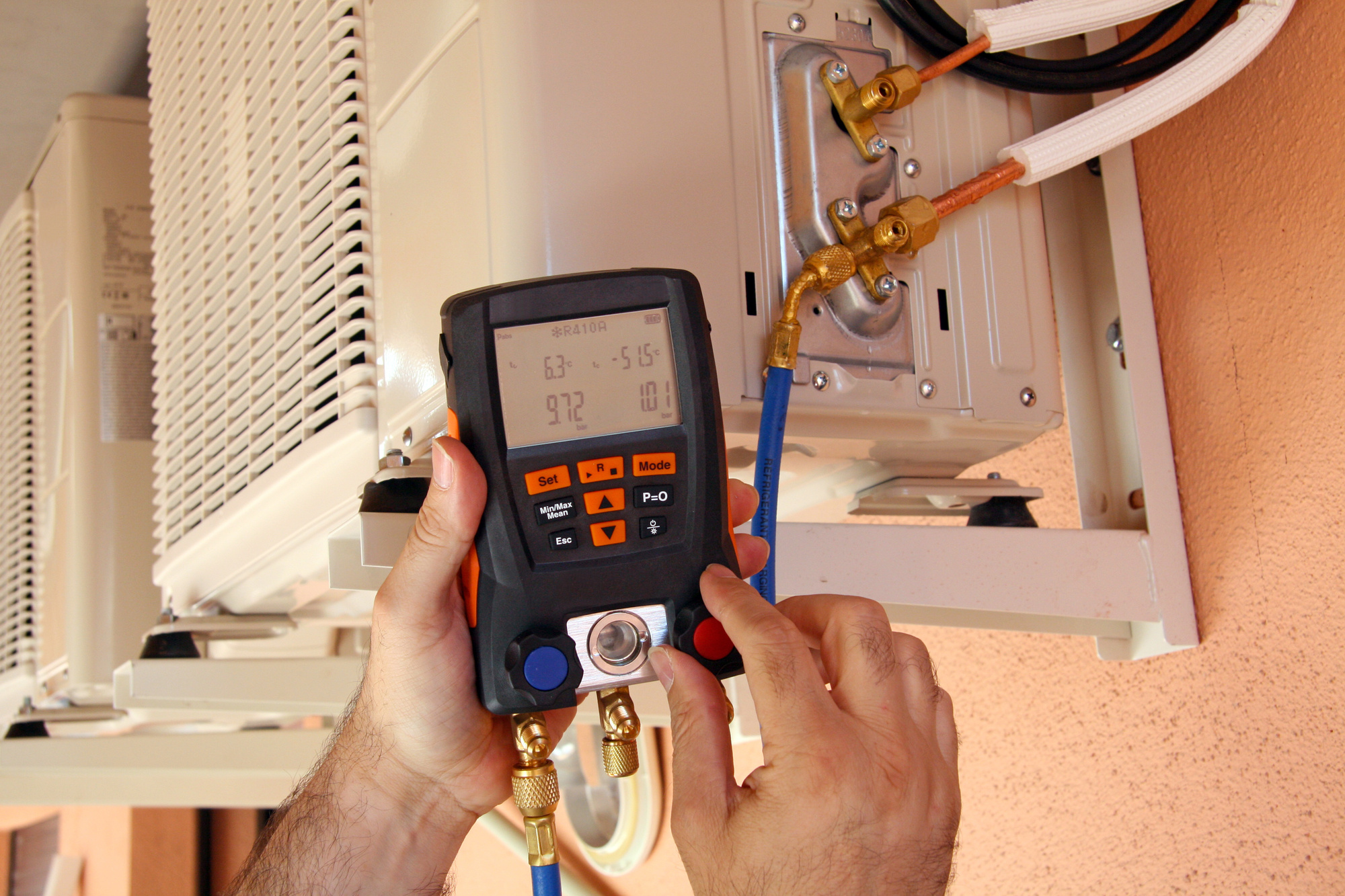 a person using a device to check the air conditioner