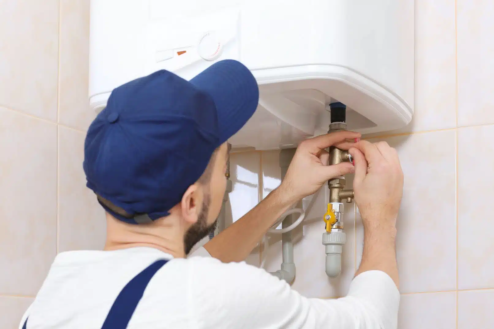 a person fixing a water heater
